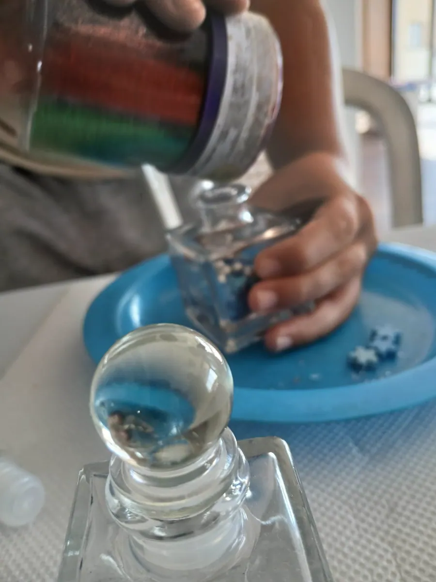 A child carefully making a Genie Jar