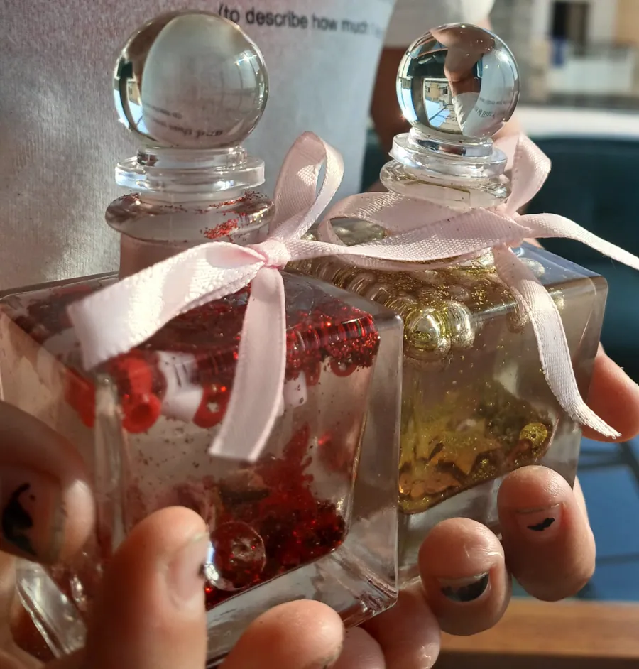 Finished red and gold Genie Jars decorated with ribbons