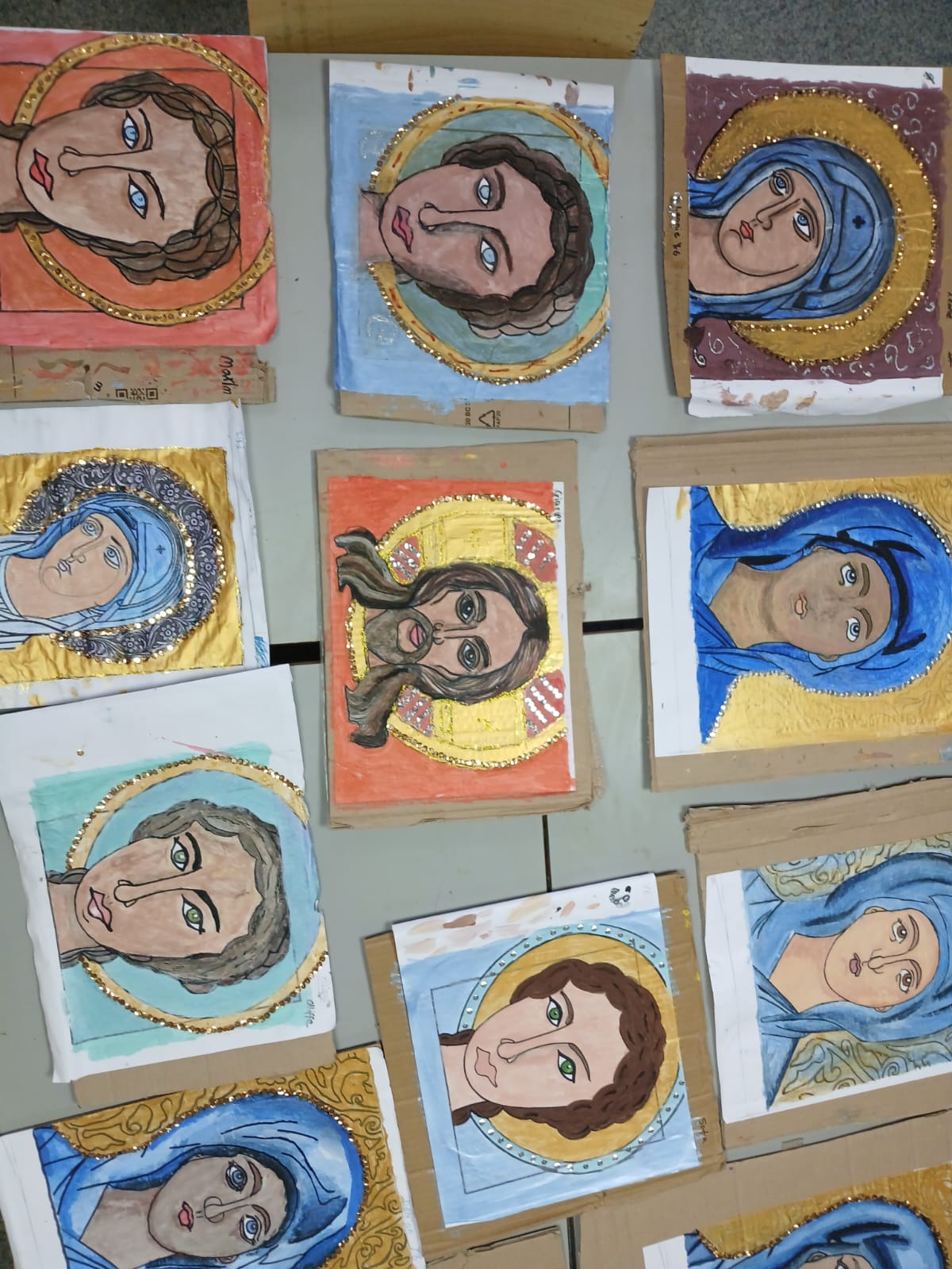 Painted icon portraits on a work table