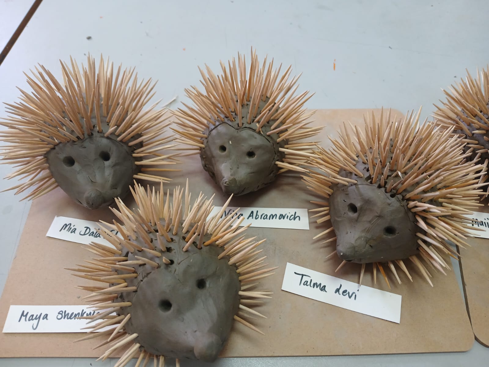 Group of clay hedgehog sculptures with name labels