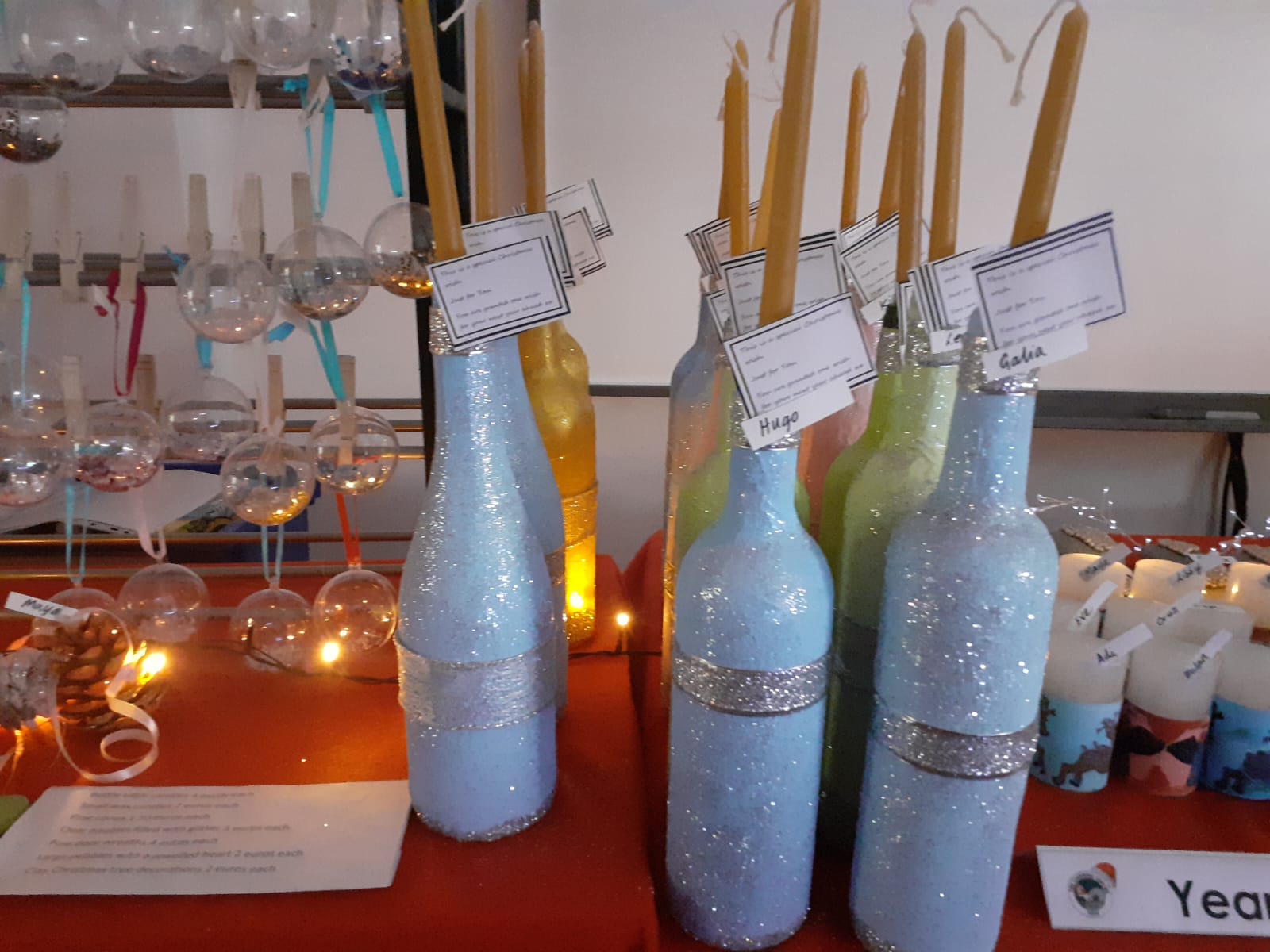 Decorated winter bottles with candles and hanging ornaments