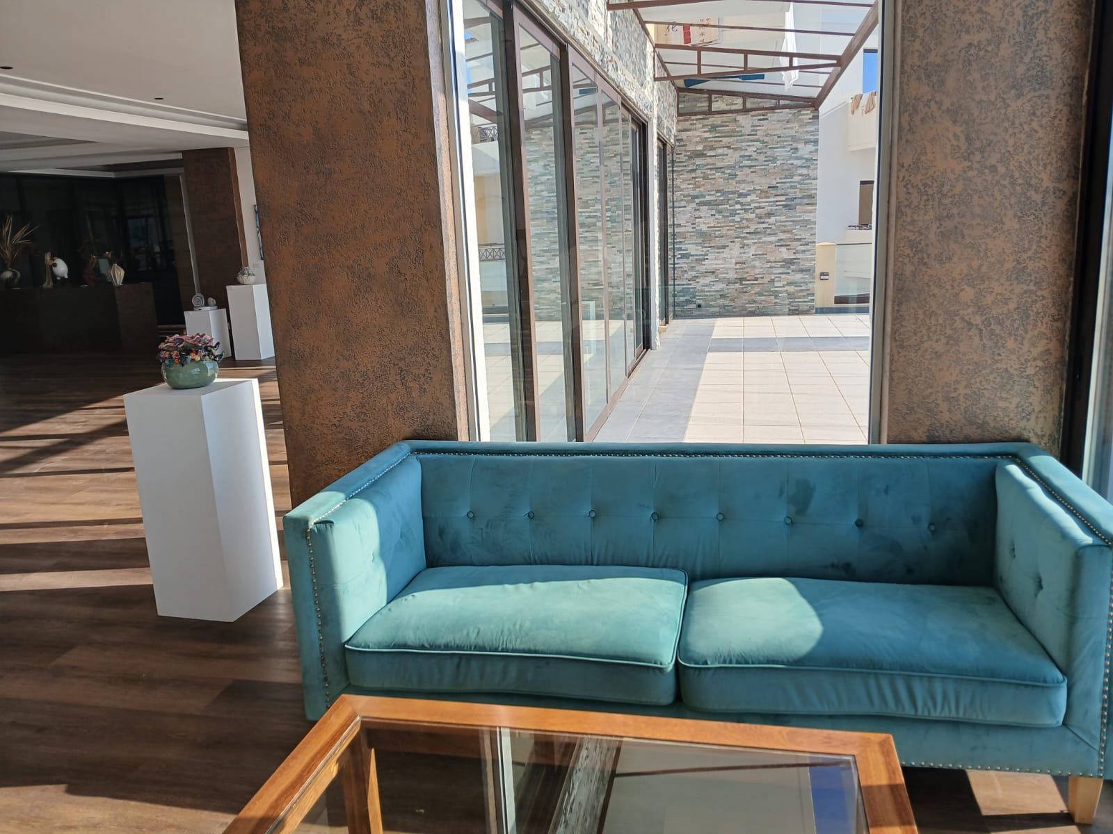 Bright Art by the Sea creative space with a turquoise sofa