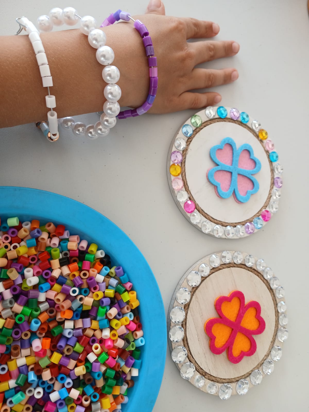 Handmade bead bracelets beside heart hoop crafts
