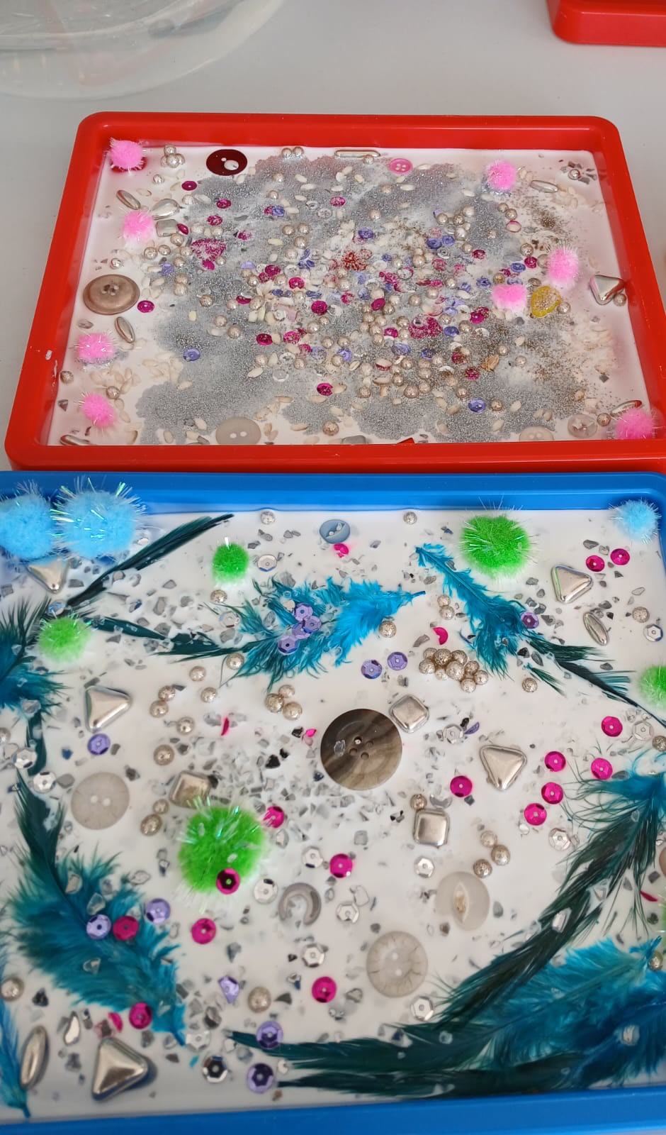 Paint bottles and colourful heart crafts on the art table