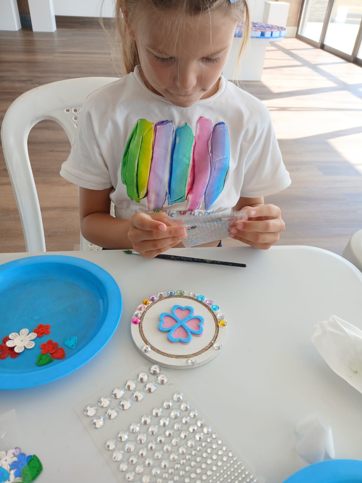 Sensory craft trays with feathers, sparkles and gems