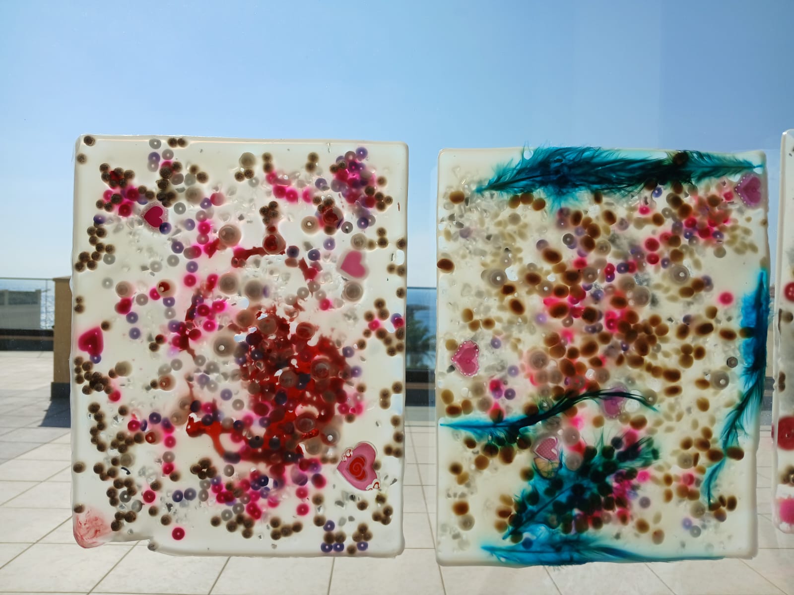 Two translucent sensory panels decorated with beads and hearts